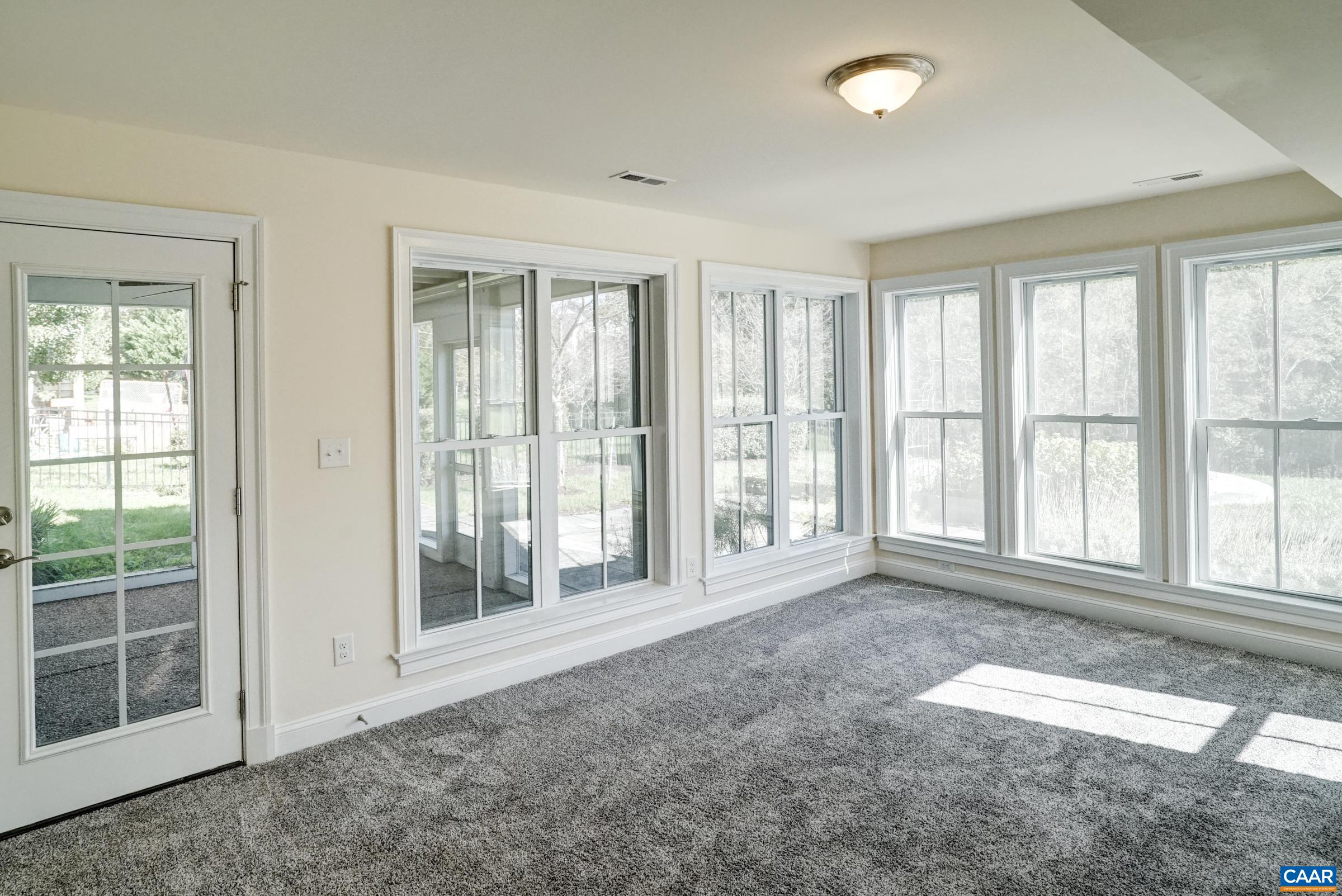 Basement sunroom with screened porch access. Basement sunroom with screened porch access.