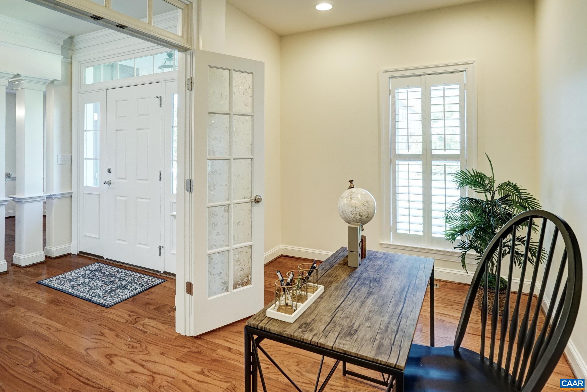 White wood shutters and Hunter Douglas shades throughout the home provide light control and privacy. White wood shutters and Hunter Douglas shades throughout the home provide light control and privacy.