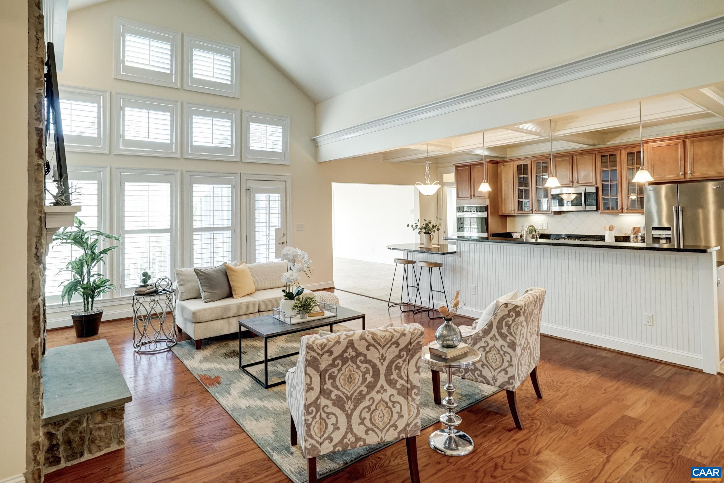 Vaulted great room with wall of windows opens to gourmet kitchen. Vaulted great room with wall of windows opens to gourmet kitchen.