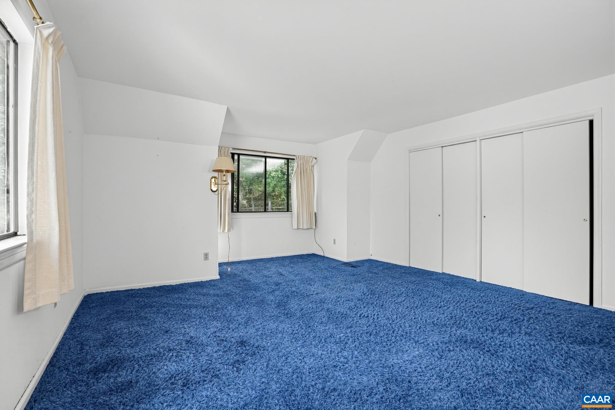 End of hallway bedroom with windows End of hallway bedroom with windows