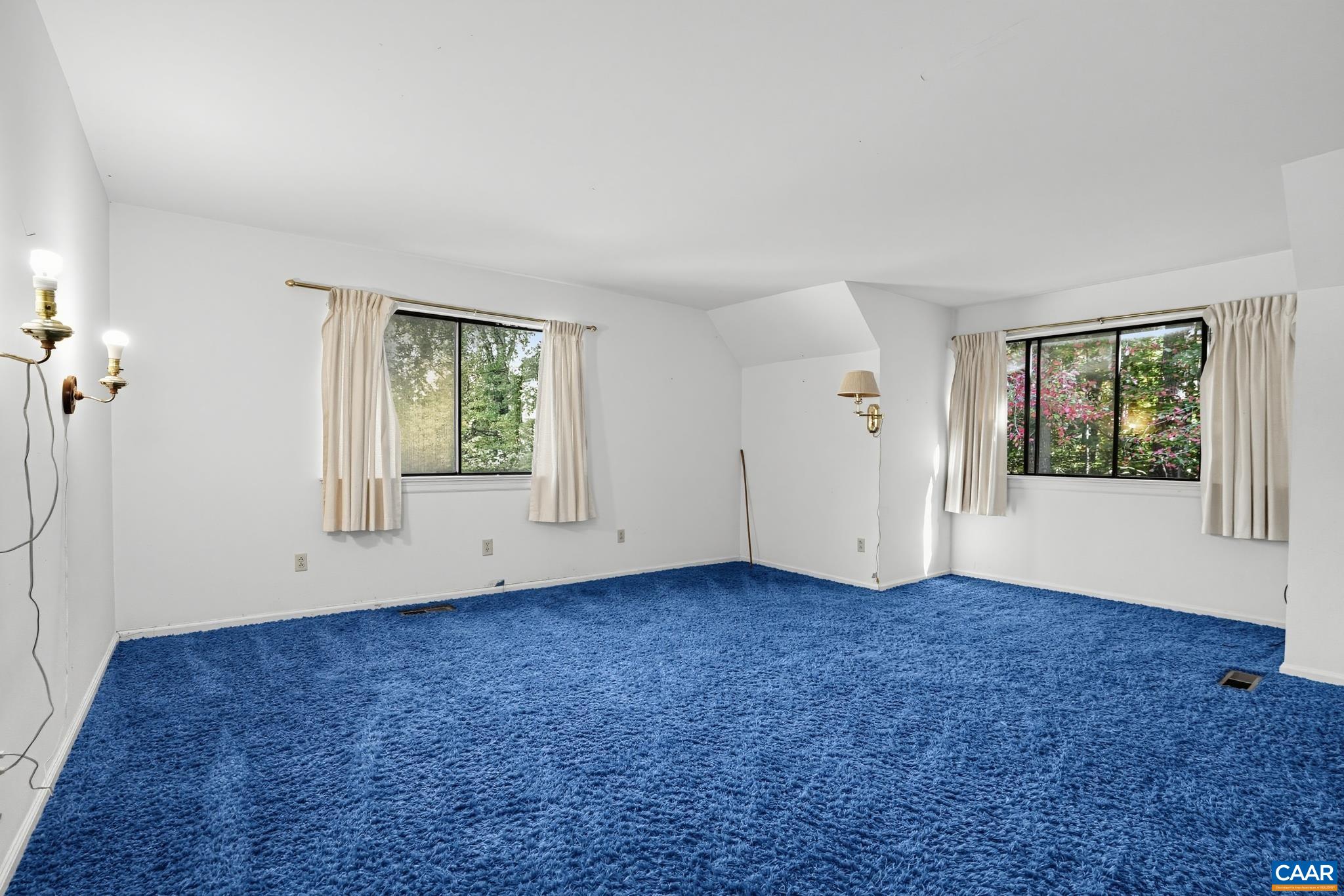 End of hallway bedroom with windows End of hallway bedroom with windows