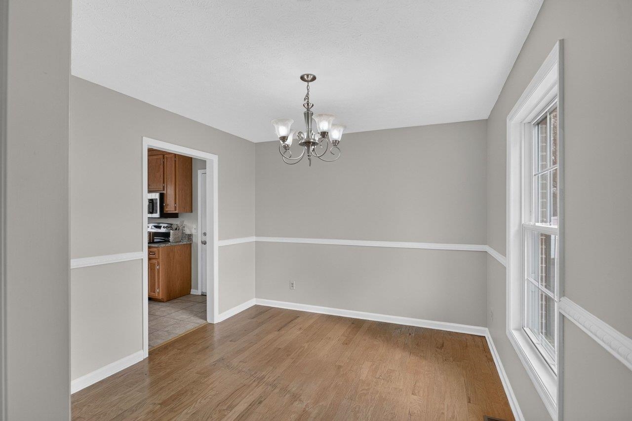The dining room features hardwood floors and provides additional space for entertaining family and friends.