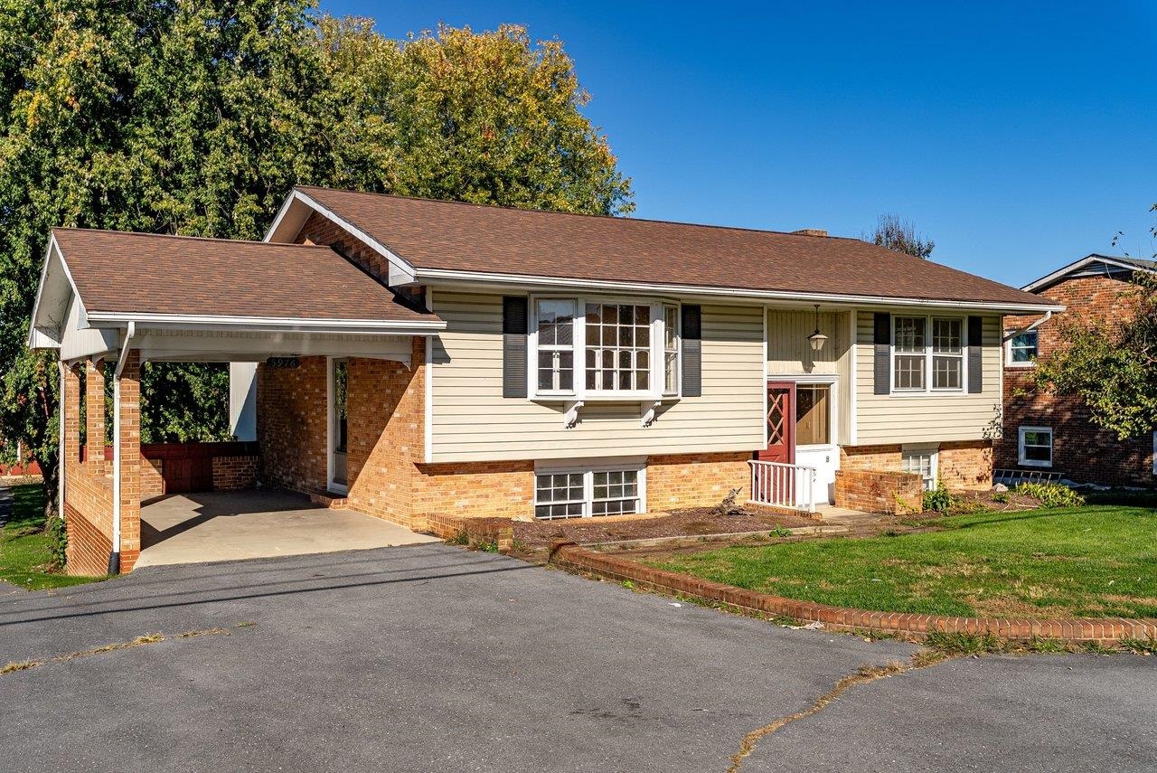 This split foyer home features low-maintenance brick and vinyl siding, along with a convenient one-car carport and paved driveway.