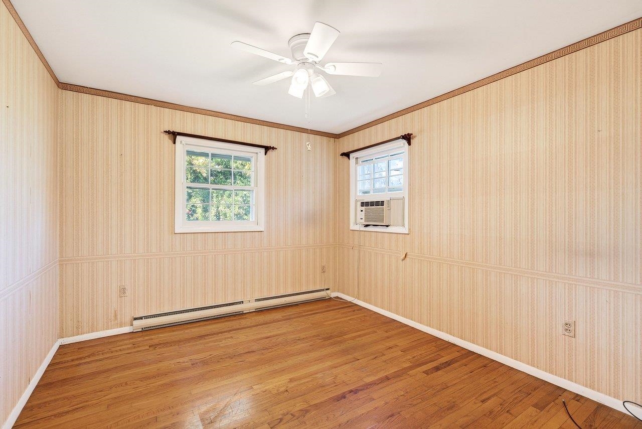 Features hardwood floors and a ceiling fan.