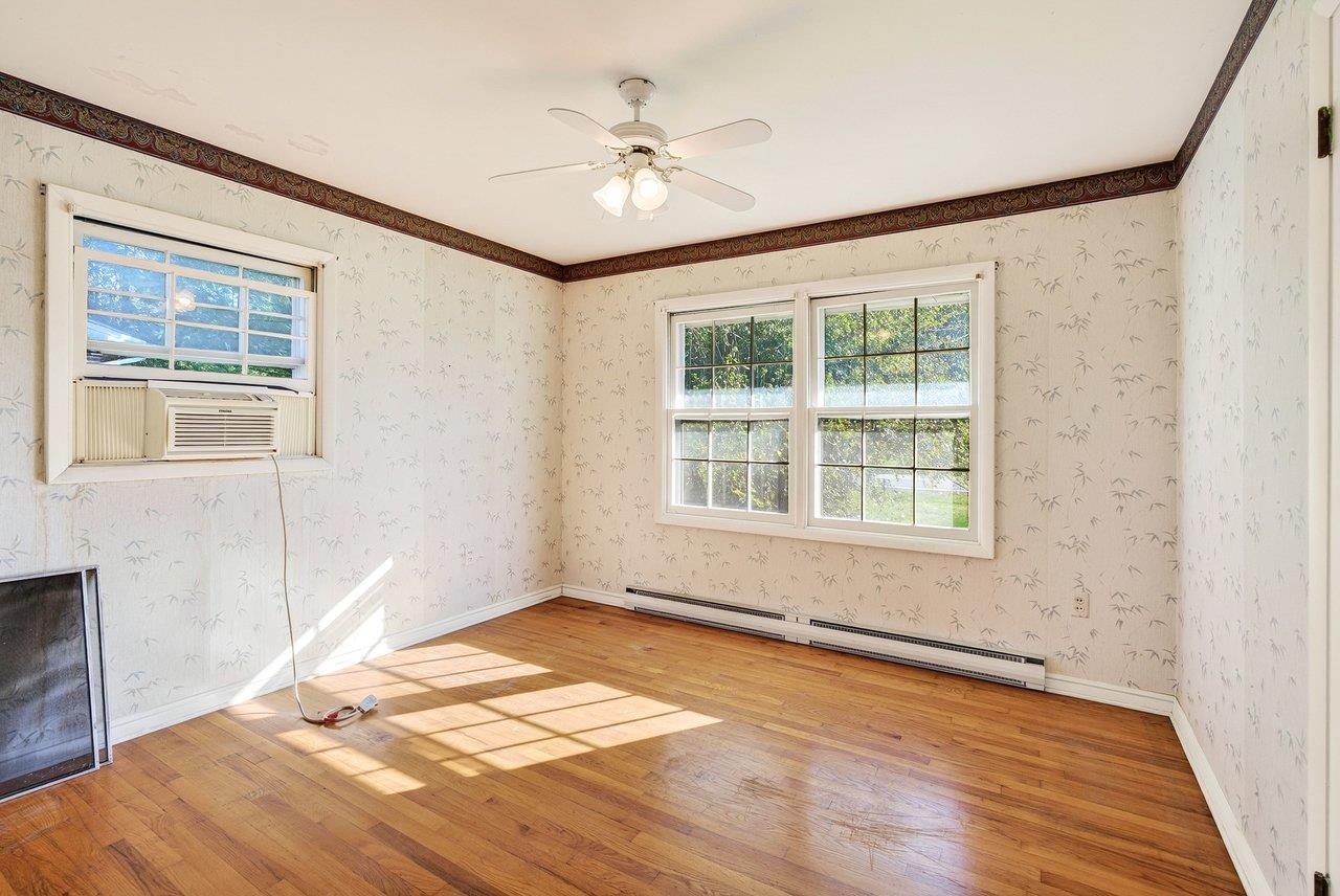 Features hardwood floors and a ceiling fan.