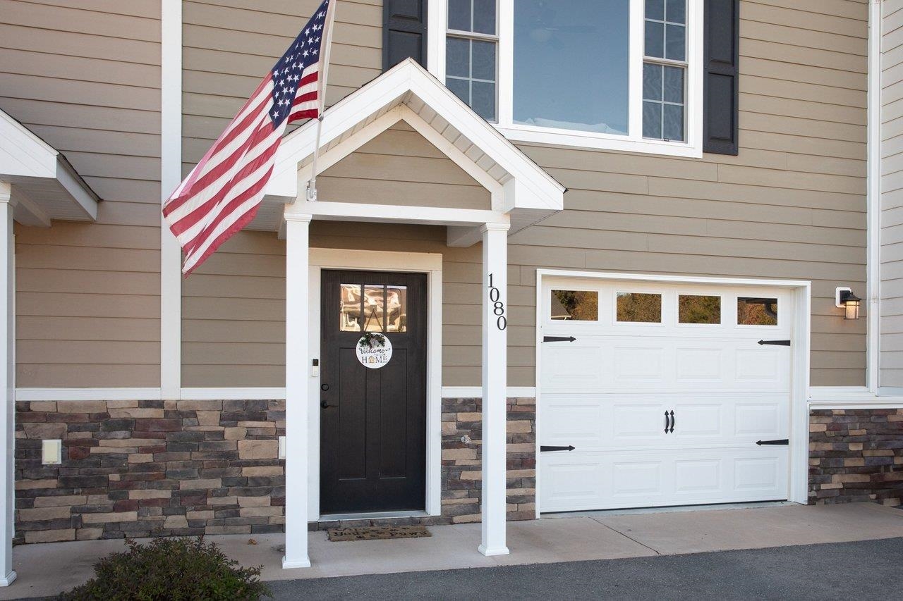 A covered front porch entry adds a welcoming touch to the home.