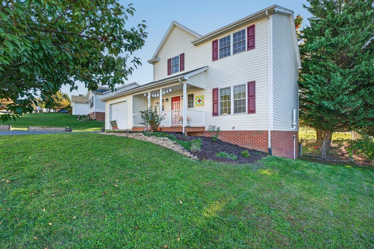 The exterior of this home is maintenance free vinyl and brick and features a front porch, single car garage and paved driveway.