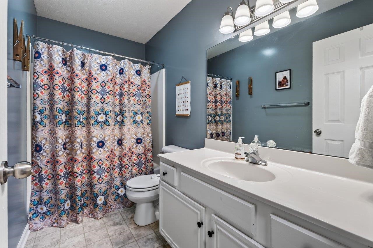 The full bath features vinyl flooring, a white vanity, and a tub/shower combination. Conveniently located near bedrooms 2 and 3.