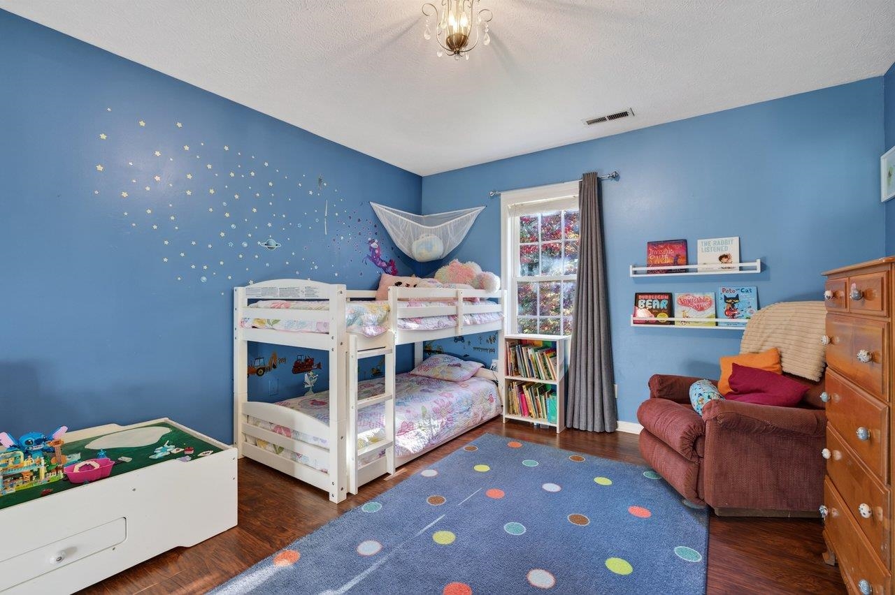 This spacious bedroom features new luxury vinyl plank flooring and offers plenty of room for a child's bedroom.