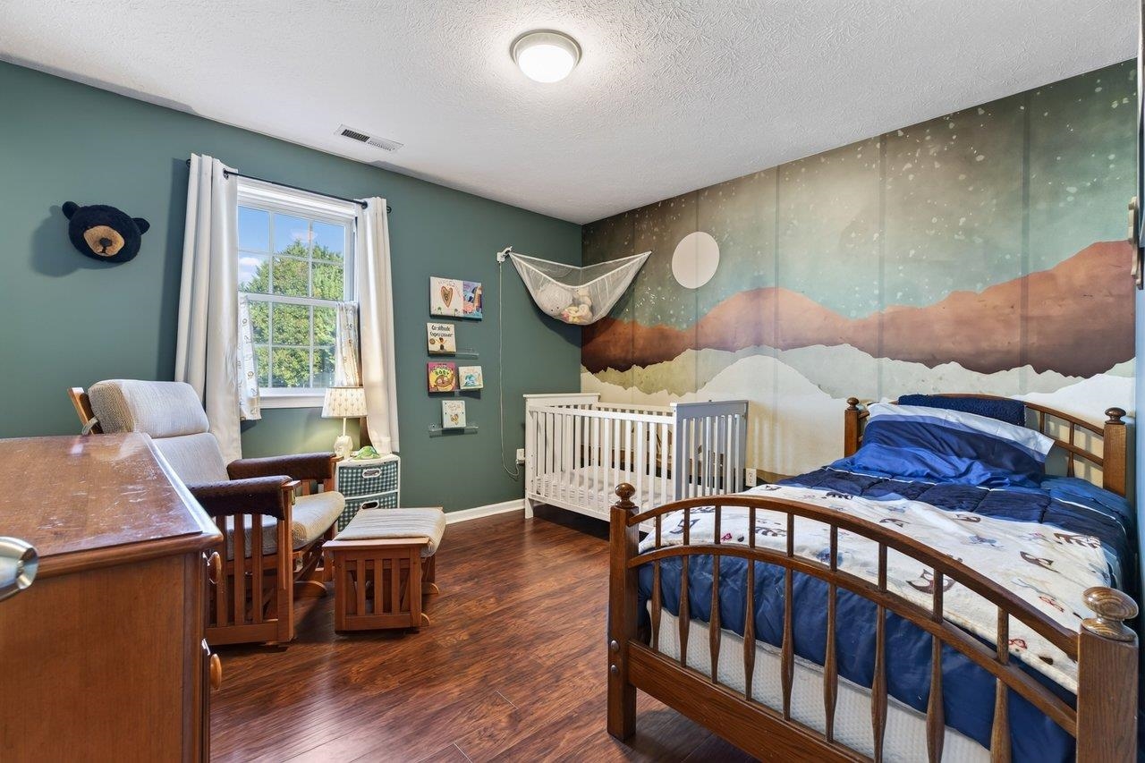 This nicely sized bedroom features new luxury vinyl plank flooring and adorable décor, making it a great space for a child’s room.