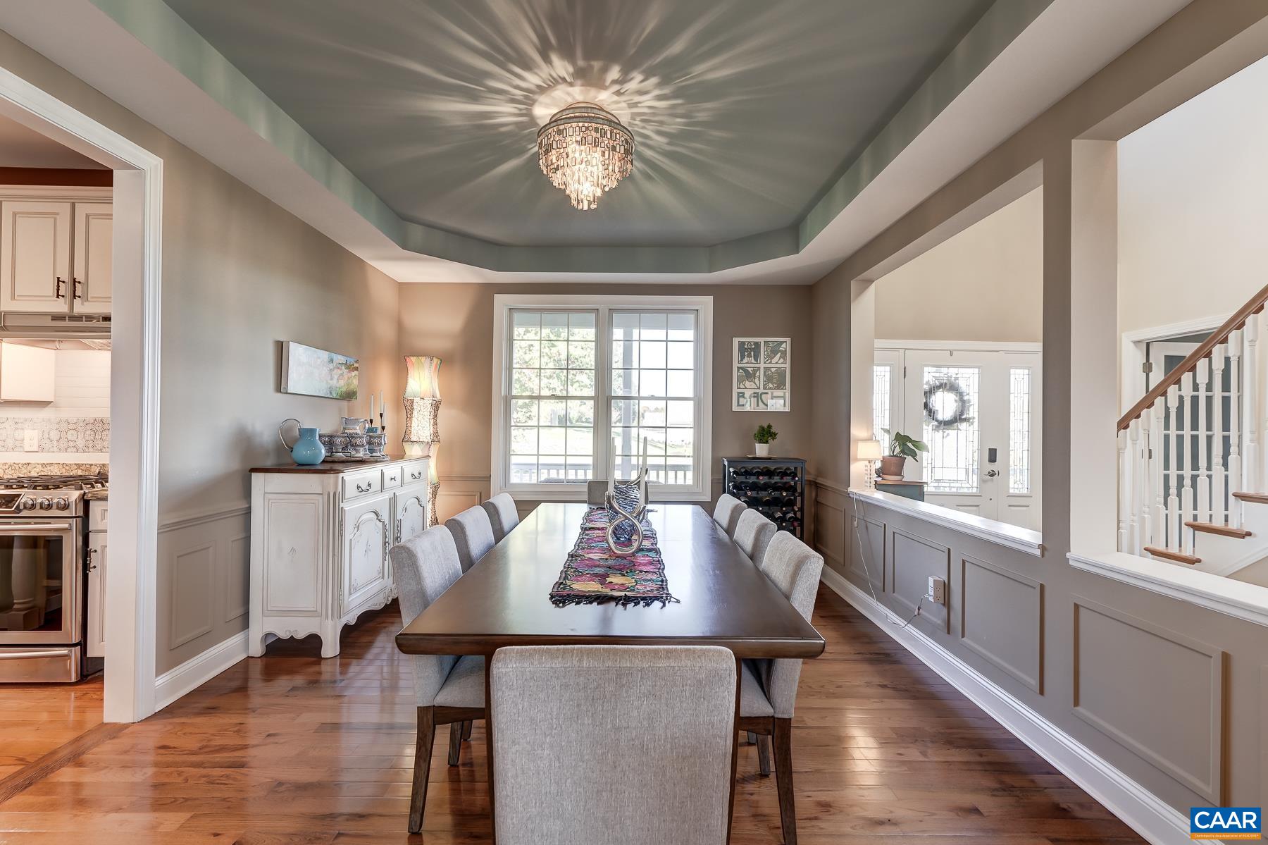 Dining room with wainscoting details and modern lighting. Dining room with wainscoting details and modern lighting.