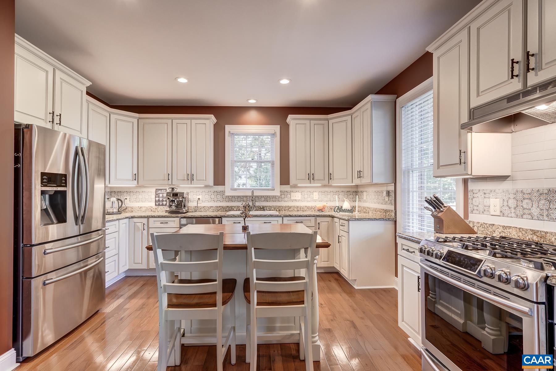 Gourmet kitchen features granite counters, white cabinets and new tile backsplash. Gourmet kitchen features granite counters, white cabinets and new tile backsplash.