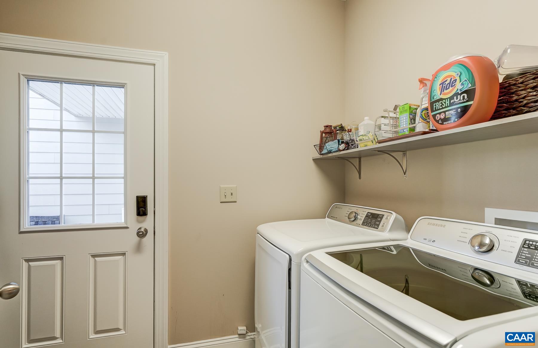 Laundry room/mudroom with door leading to detached garage. Laundry room/mudroom with door leading to detached garage.
