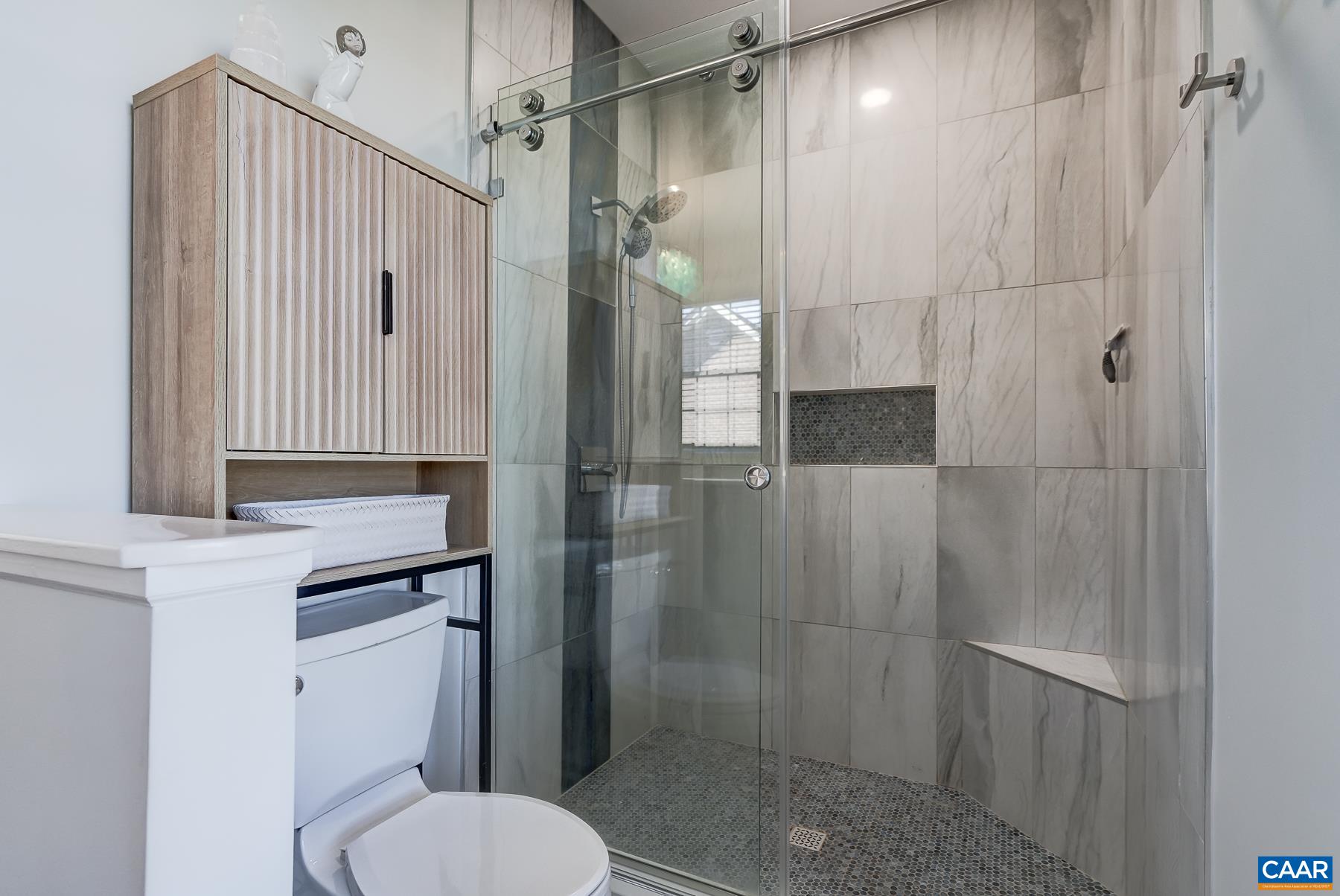 Walk in shower features sliding door. Walk in shower features sliding door.