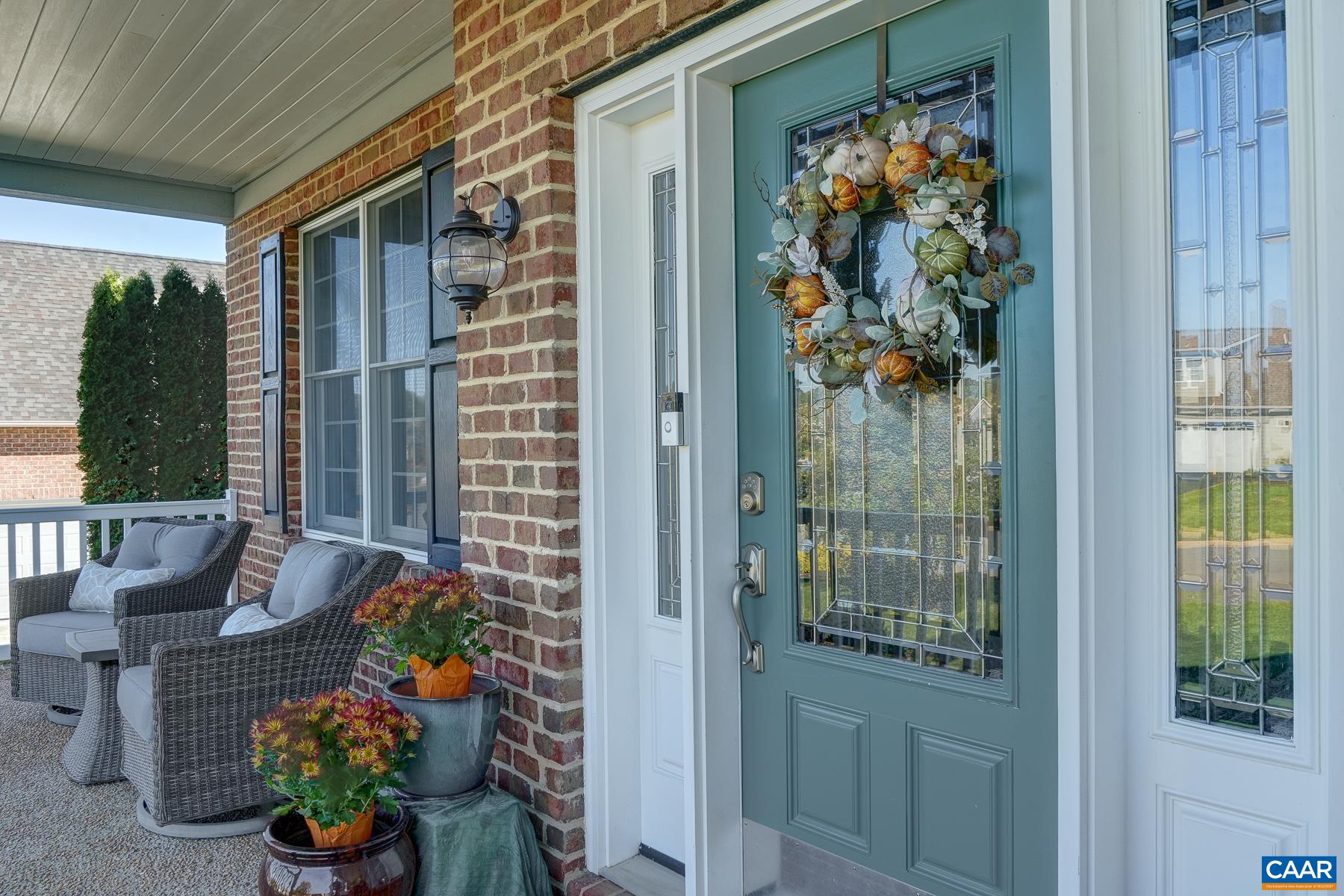 Covered front porch with front door featuring leaded glass. Covered front porch with front door featuring leaded glass.