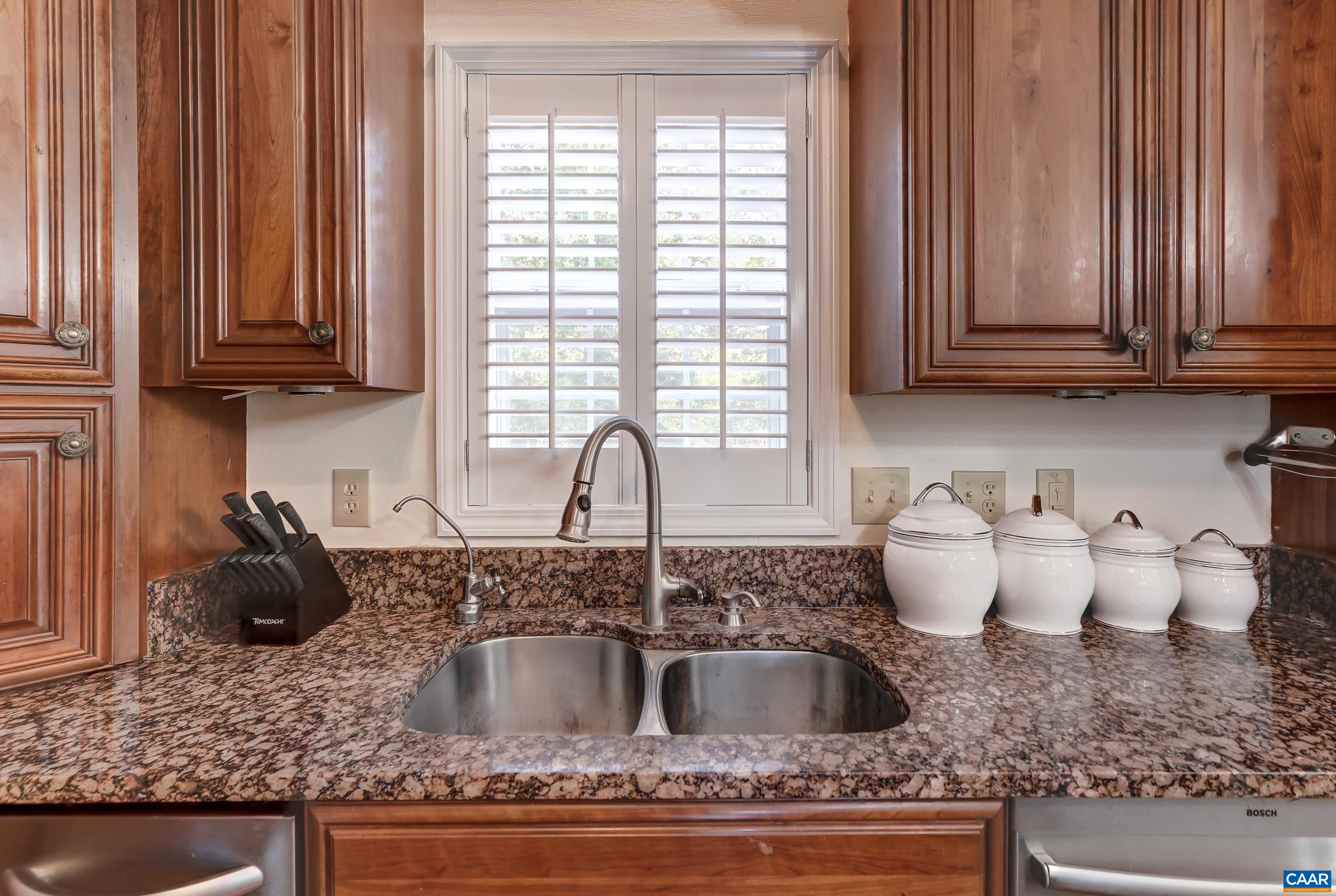 Wood shutters over sink. Wood shutters over sink.