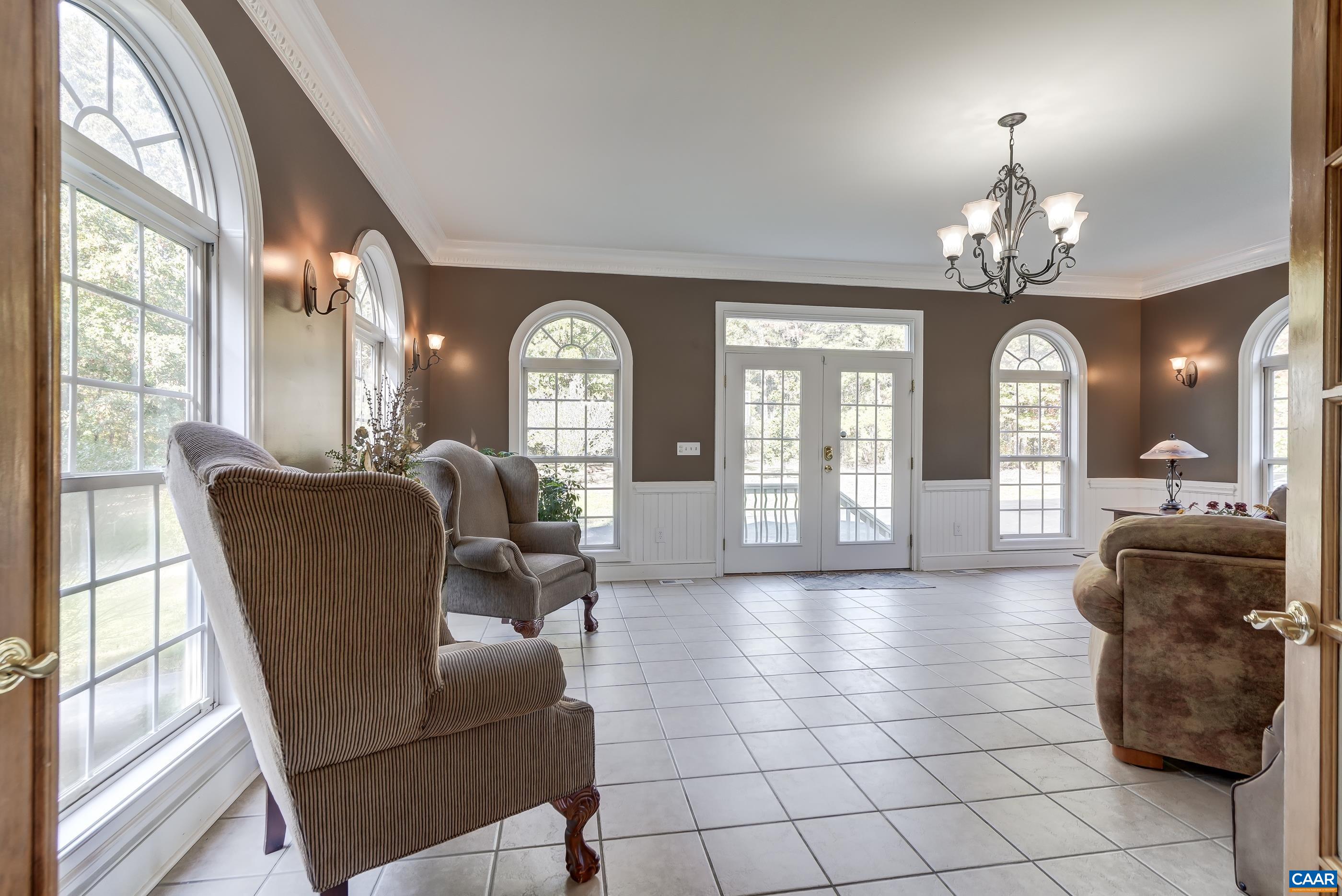 Enjoy relaxation and gather with friends in the light-filled sunroom with new french doors to exterior. Enjoy relaxation and gather with friends in the light-filled sunroom with new french doors to exterior.
