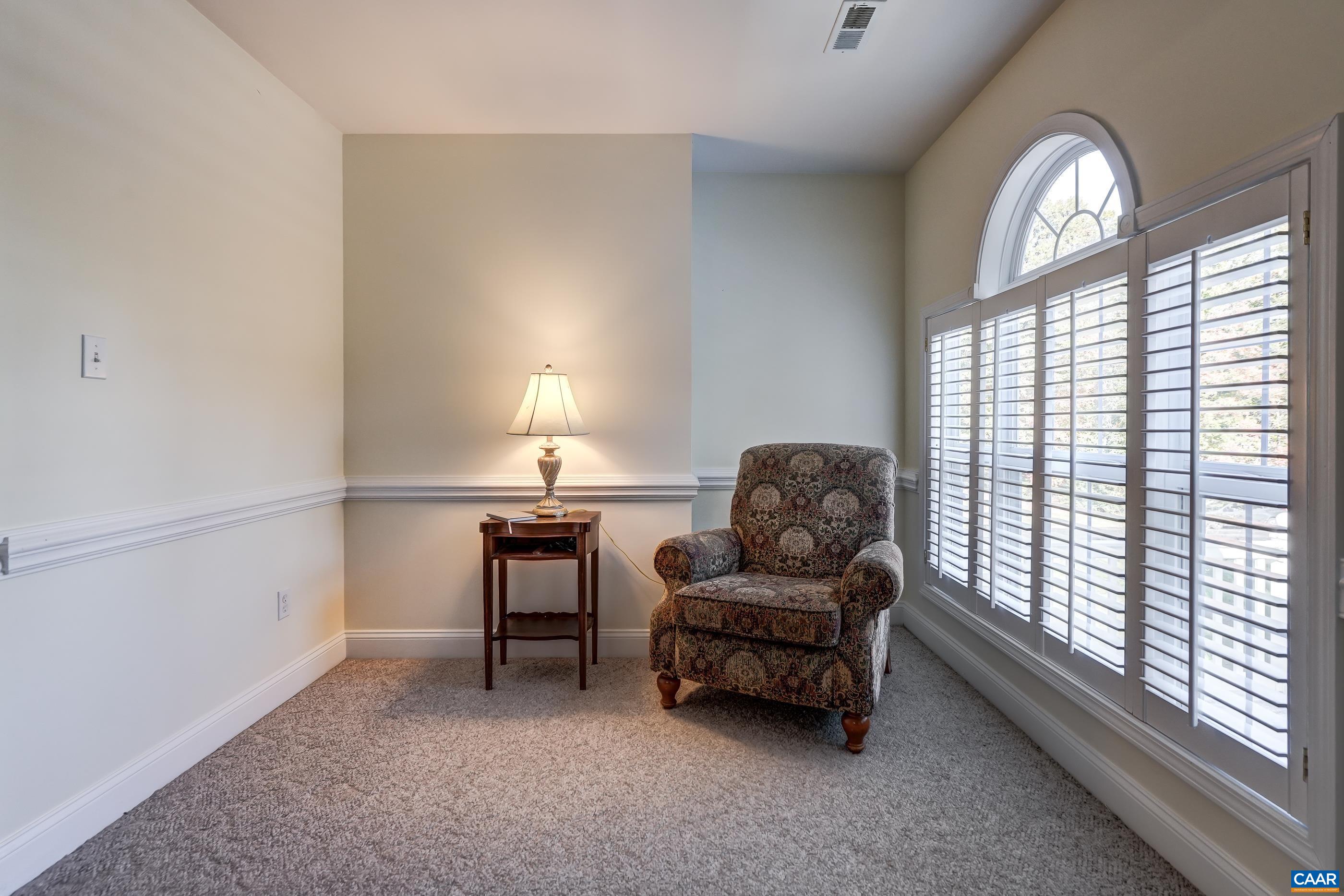 Sitting room/nursery attaches to primary bedroom and features wooden shutter blinds. Sitting room/nursery attaches to primary bedroom and features wooden shutter blinds.