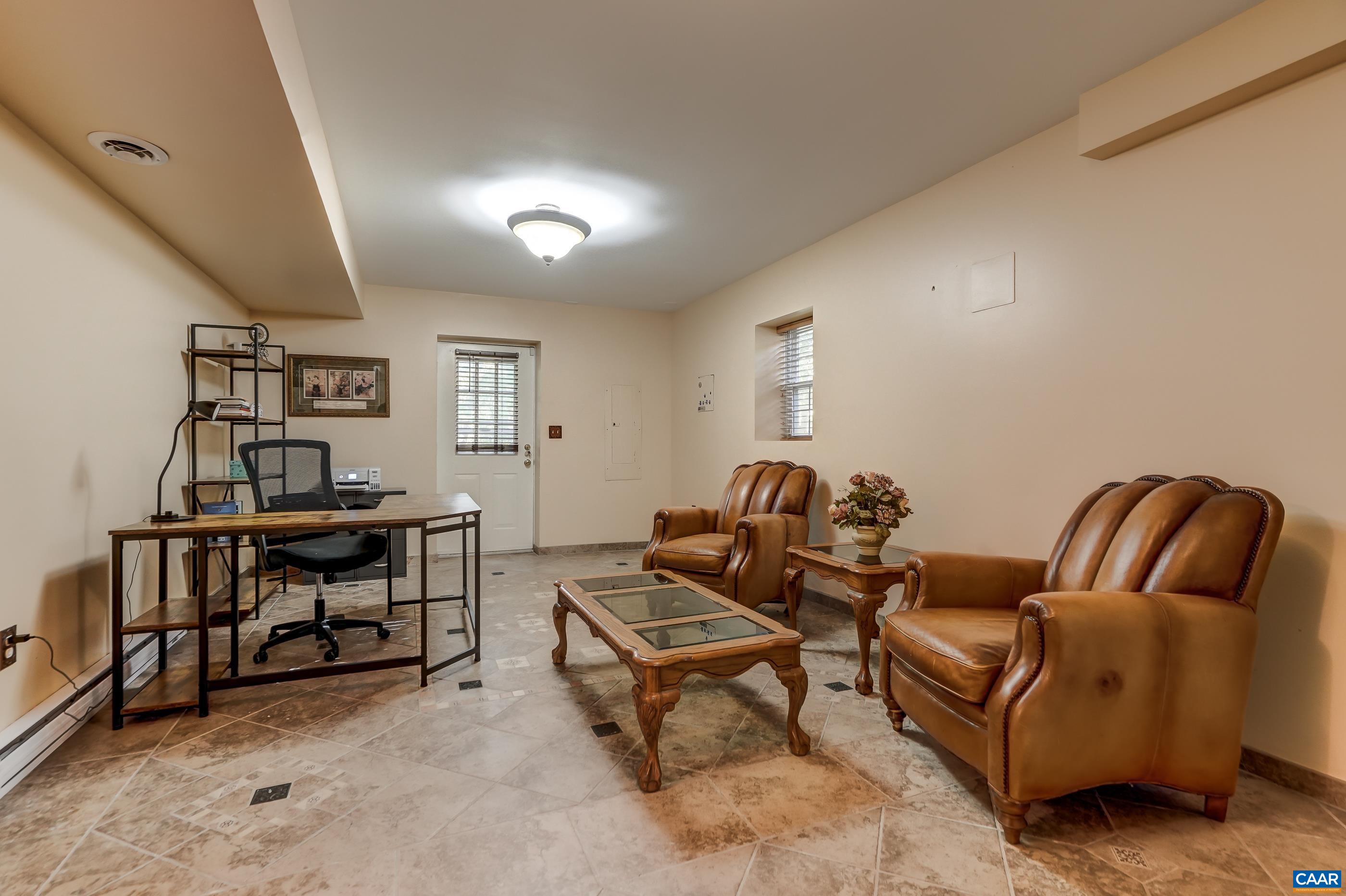 Large basement rec room with ceramic tile flooring and access to the outdoors. Large basement rec room with ceramic tile flooring and access to the outdoors.