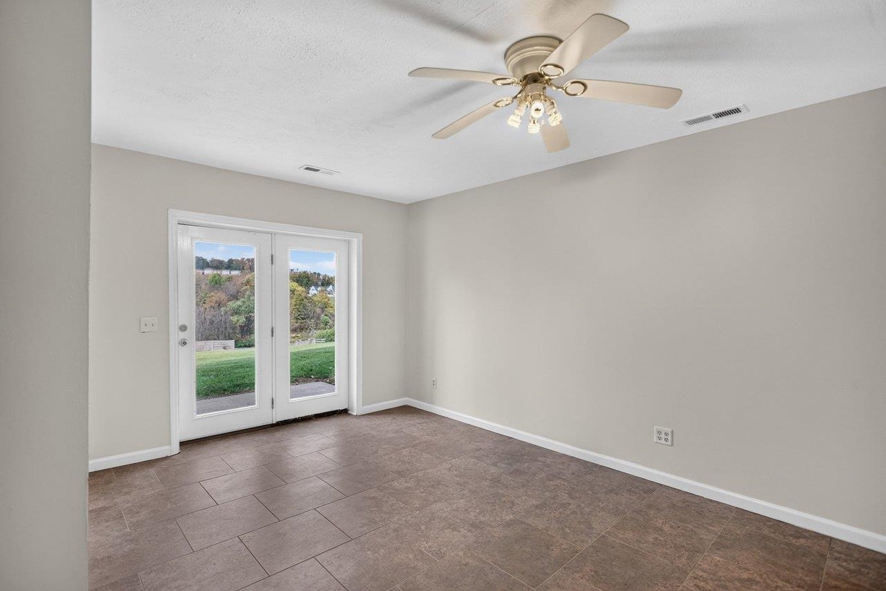 The tile-floored room offers flexible space for a variety of uses, including a fourth bedroom, rec room, or home office. The tile-floored room offers flexible space for a variety of uses, including a fourth bedroom, rec room, or home office.